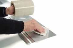 Hand putting plastic seal on EDGE-CUTTER