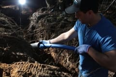 Contractor installing insulation on pipe at job site