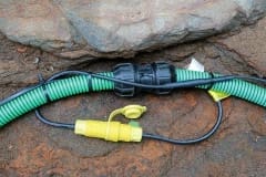 Inter-connecting, self-regulating heat trace system on pipe outdoors in dirt