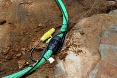 Inter-connecting, self-regulating heat trace system on pipe outdoors in dirt