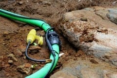 Inter-connecting, self-regulating heat trace system on pipe outdoors in dirt