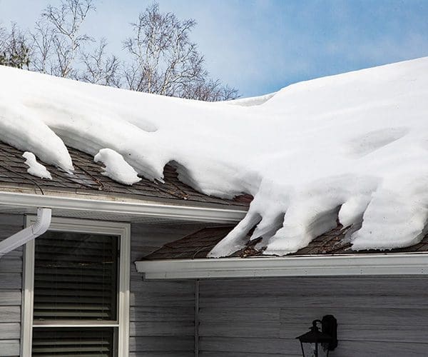 Roof de-icing heating cable system on roof in Winter