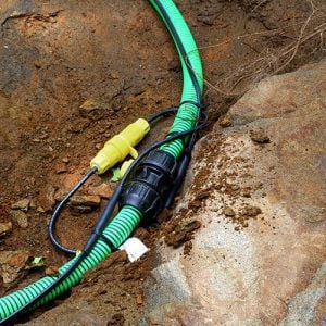 Inter-connecting, self-regulating heat trace system on pipe outdoors in dirt